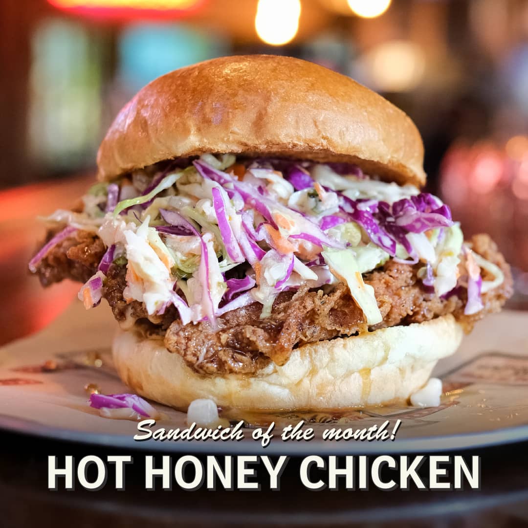 Promotional image for May's Sandwich of the Month at Carol's Pub: Carol's Hot Honey Chicken Sandwich