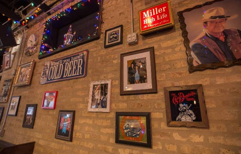 Framed photos of country music artists at Carol's Pub 