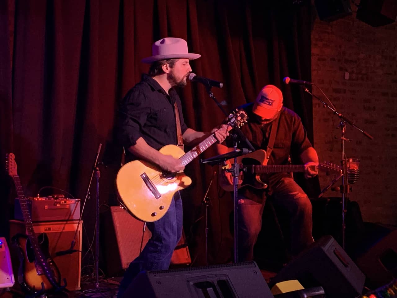 Two guitar players performing at Carol's Pub